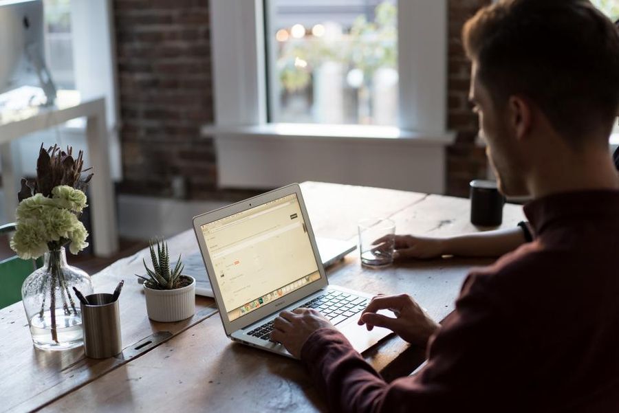 Person working at a laptop in a bright office